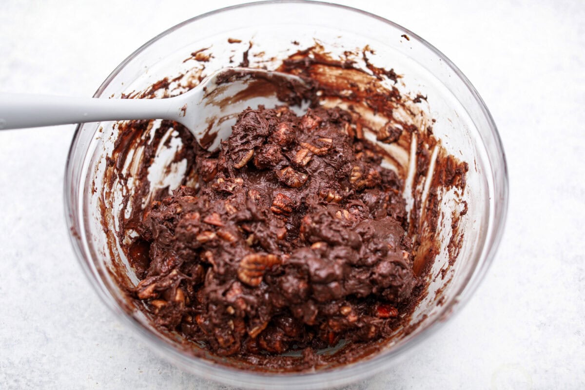 These decadent rocky road bars are the best no-bake treat that you can whip up in no time when that sweet tooth hits. Fudgy chocolate, soft marshmallows, and chewy pecans combine to make the most amazing dessert. Overhead shot of the rocky road bars ingredients all mixed together.