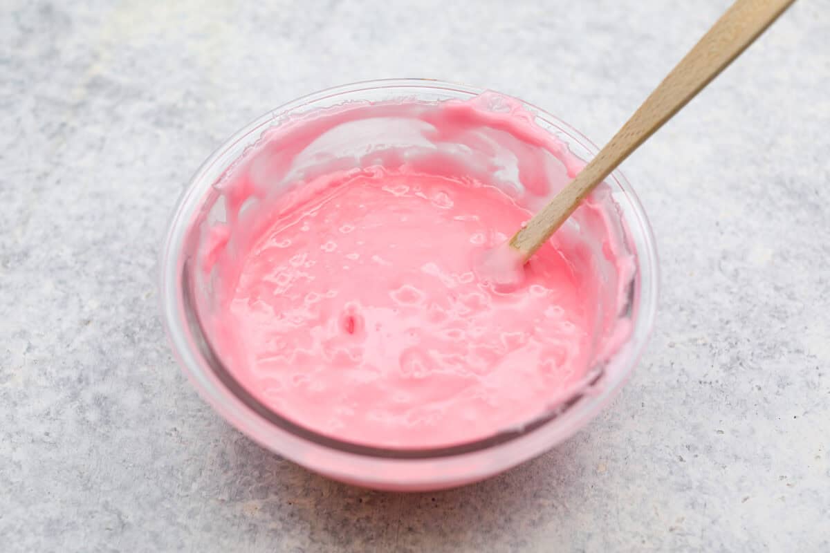 Homemade cherry cordials are a tasty, nostalgic treat! They're made with sweet cherries that are coated in a rich chocolate shell. Make them for Christmas or Valentine’s Day, and watch them disappear! Overhead shot of fondant with invertase and extract mixed in.