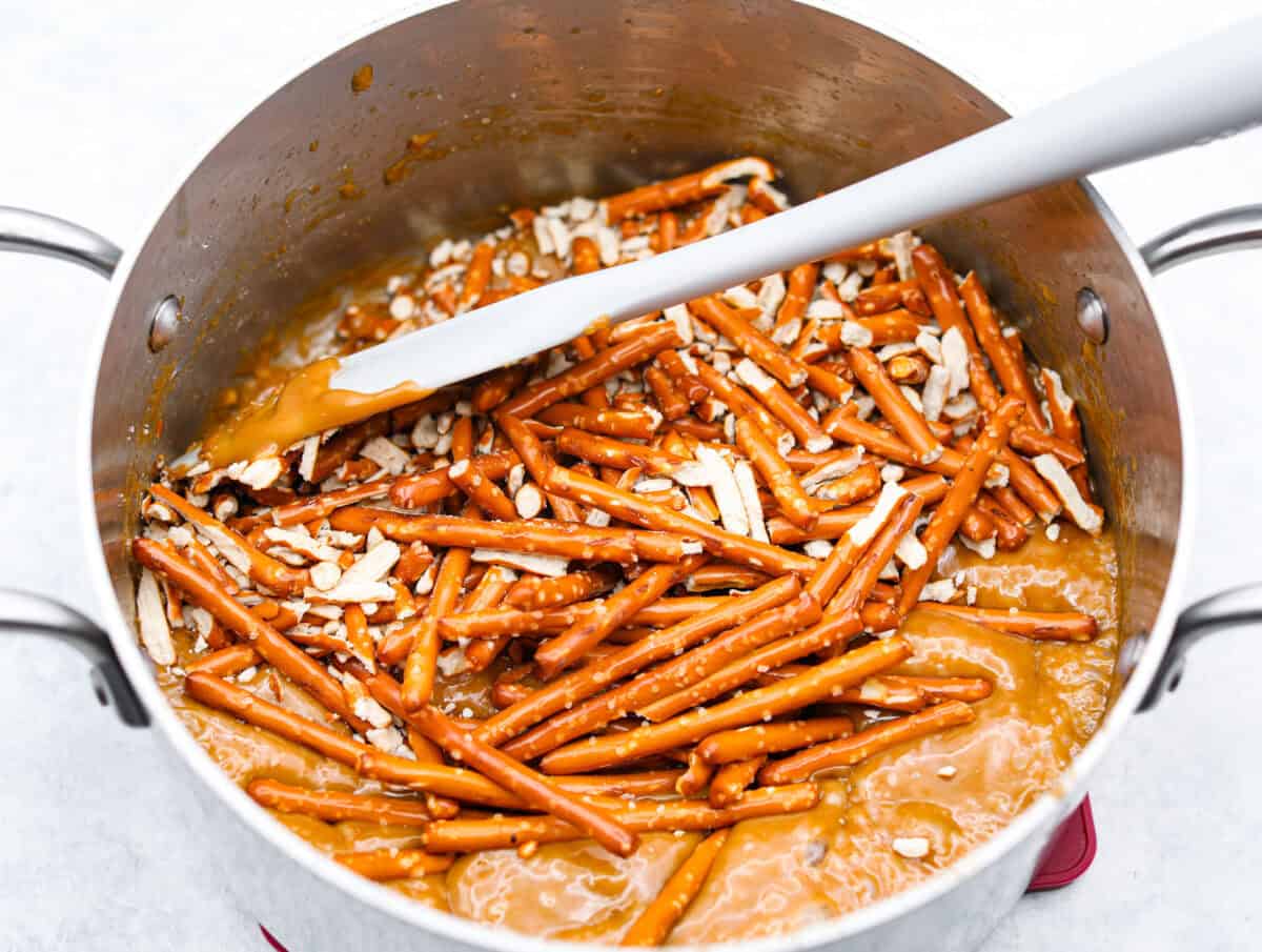 Pretzel Christmas Crack is the best holiday treat! This addictive combination of salty pretzels, rich toffee, and chocolate is sure to be a hit at any party or gathering. Overhead shot of pretzels in caramel mixture.