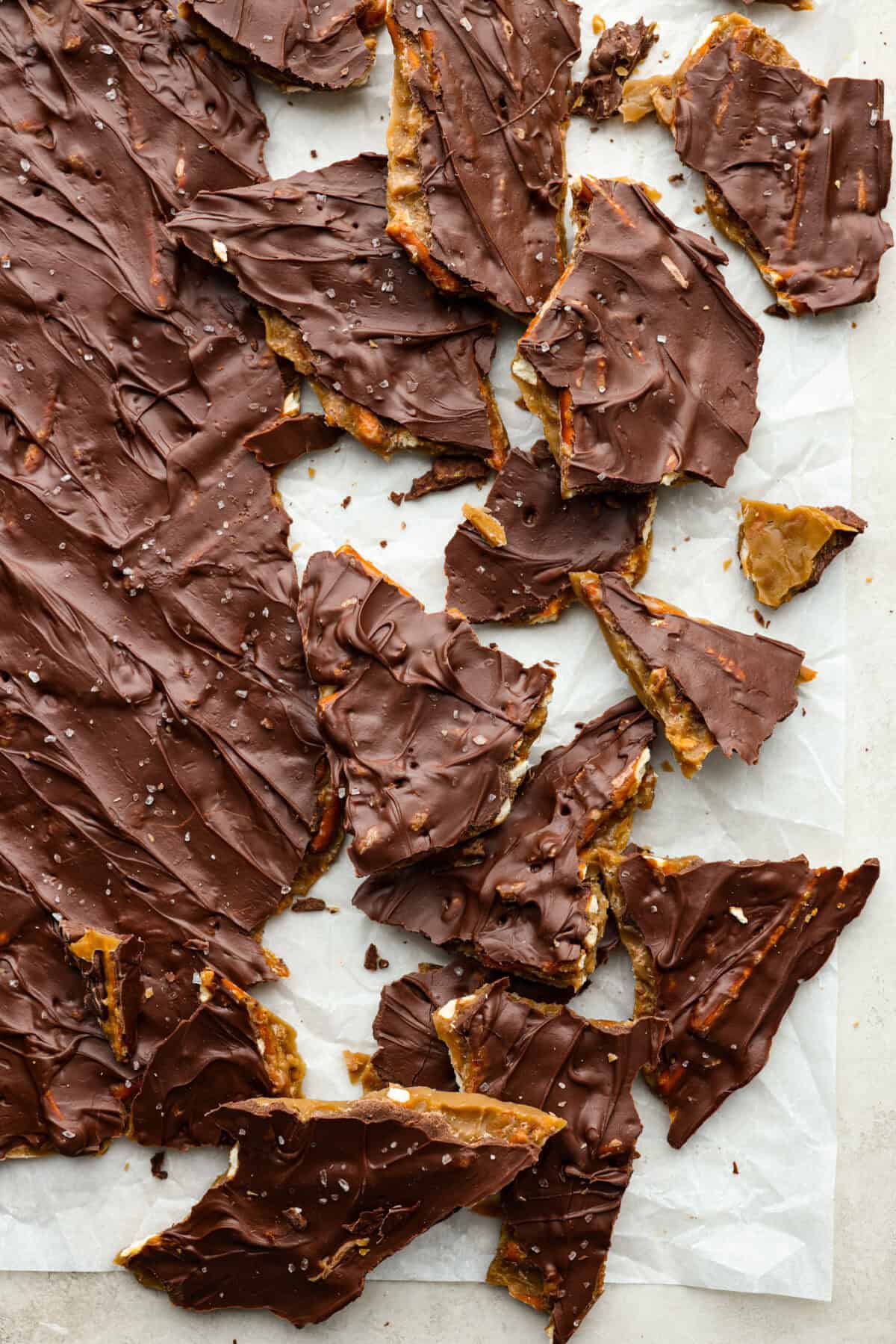 Pretzel Christmas Crack is the best holiday treat! This addictive combination of salty pretzels, rich toffee, and chocolate is sure to be a hit at any party or gathering. Overhead shot of broken up pieces of pretzel Christmas crack.