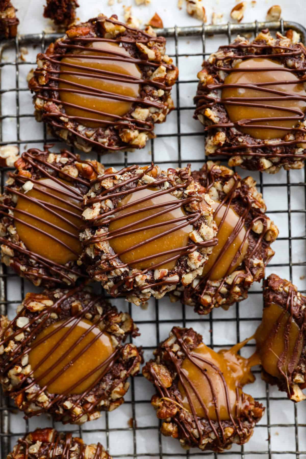 Turtle Cookies are a baked, bite-size brownie loaded with pecans, then filled with a creamy caramel center for a rich, decadent holiday cookie! These turtle cookies are always a huge hit and are gone in minutes Close up shot of turtle cookies.