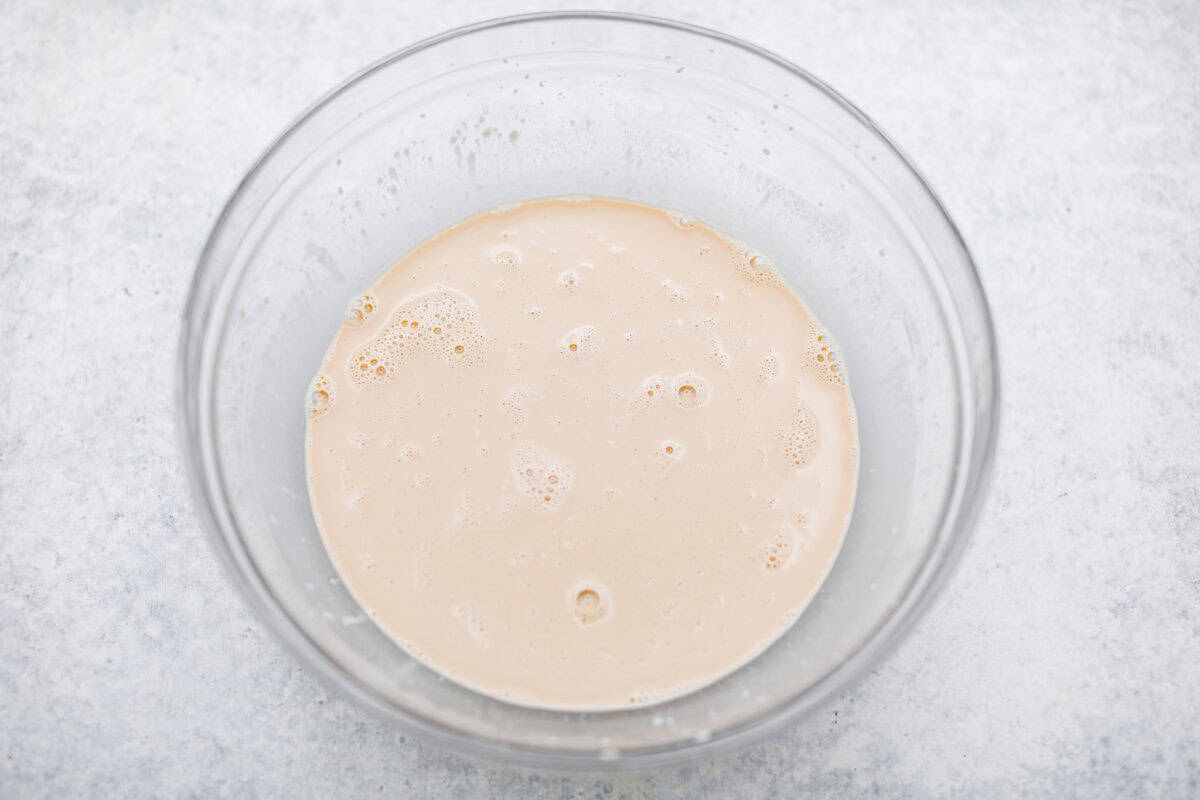 Chocolate Mayonnaise Cake is a rich, moist, and decadent dessert that’s super easy to make! The mayonnaise adds extra moisture and creates a soft, tender crumb. Whether for a special occasion or just because it's sure to impress! Overhead shot of mayonnaise, coffee, eggs and vanilla whisked together in a bowl.