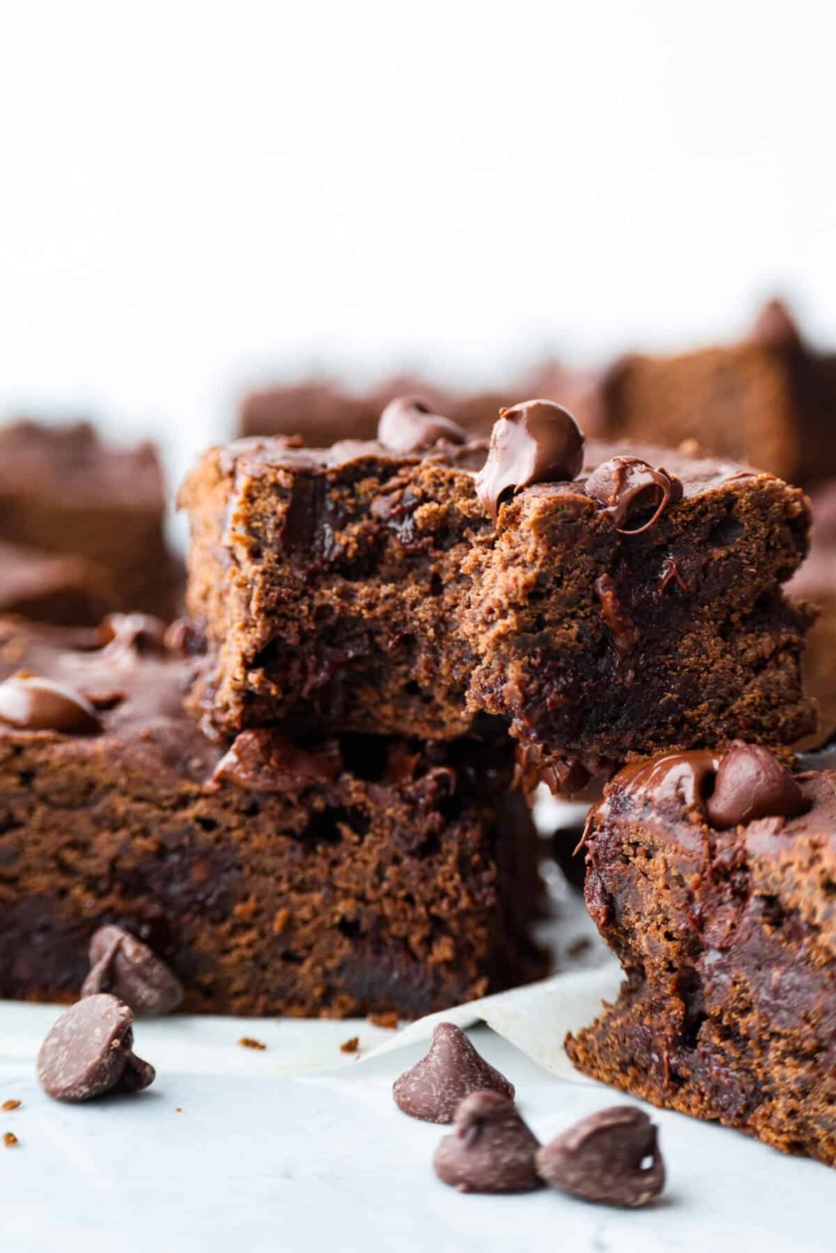 Black bean brownies are rich, fudgy, and packed with chocolatey goodness! They have a slightly denser texture, similar to a protein bar, but still satisfy that brownie craving. While adults may notice a slight difference from traditional brownies, kids won’t be able to tell! Close up shot of a black bean brownie with a bite taken out of it.